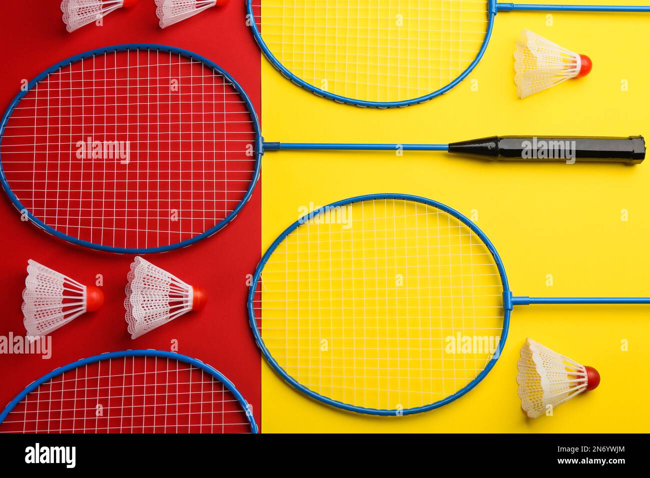 Badminton rackets and shuttlecocks on color background, flat lay Stock Photo