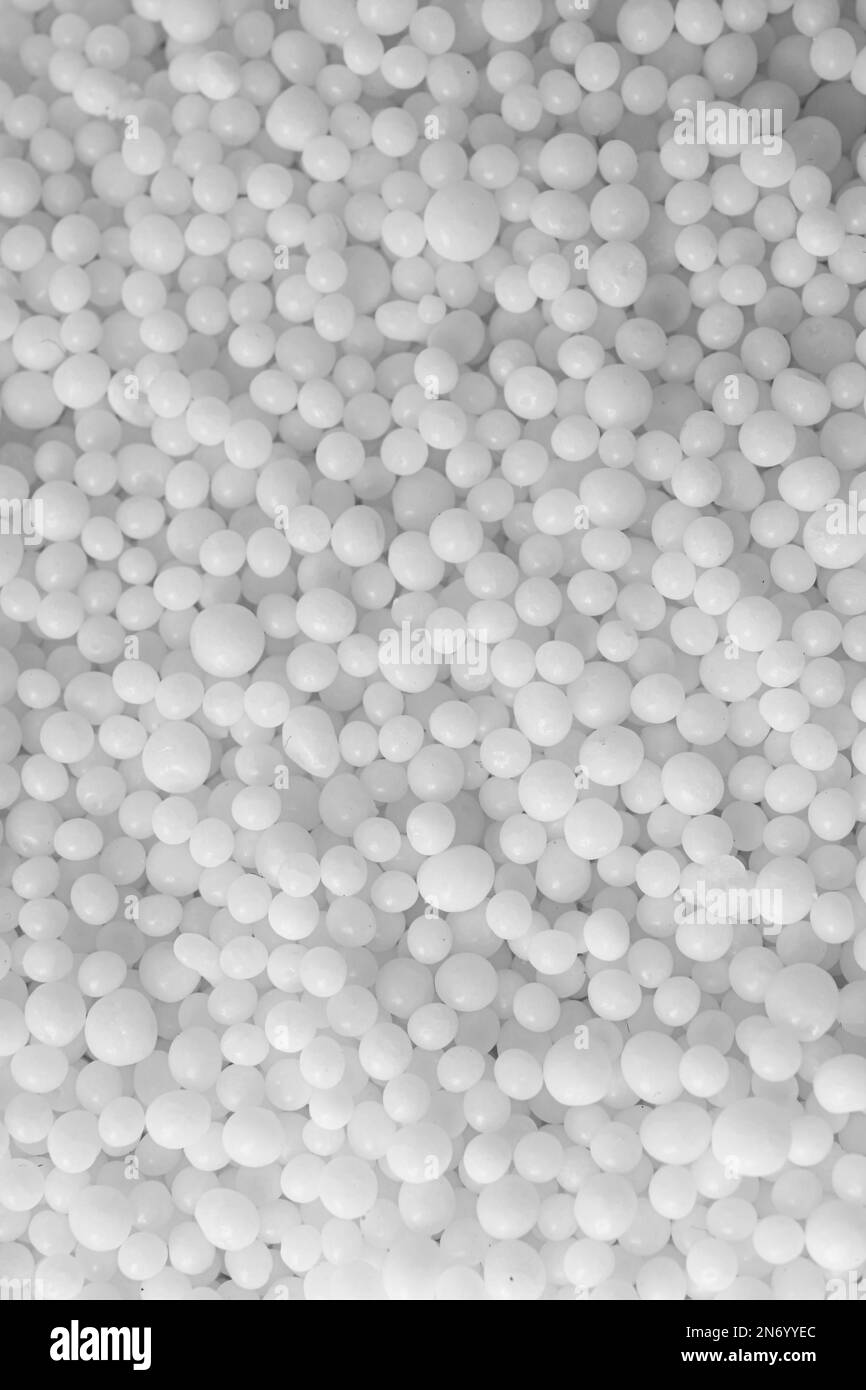 Pellets of ammonium nitrate as background, top view. Mineral fertilizer Stock Photo