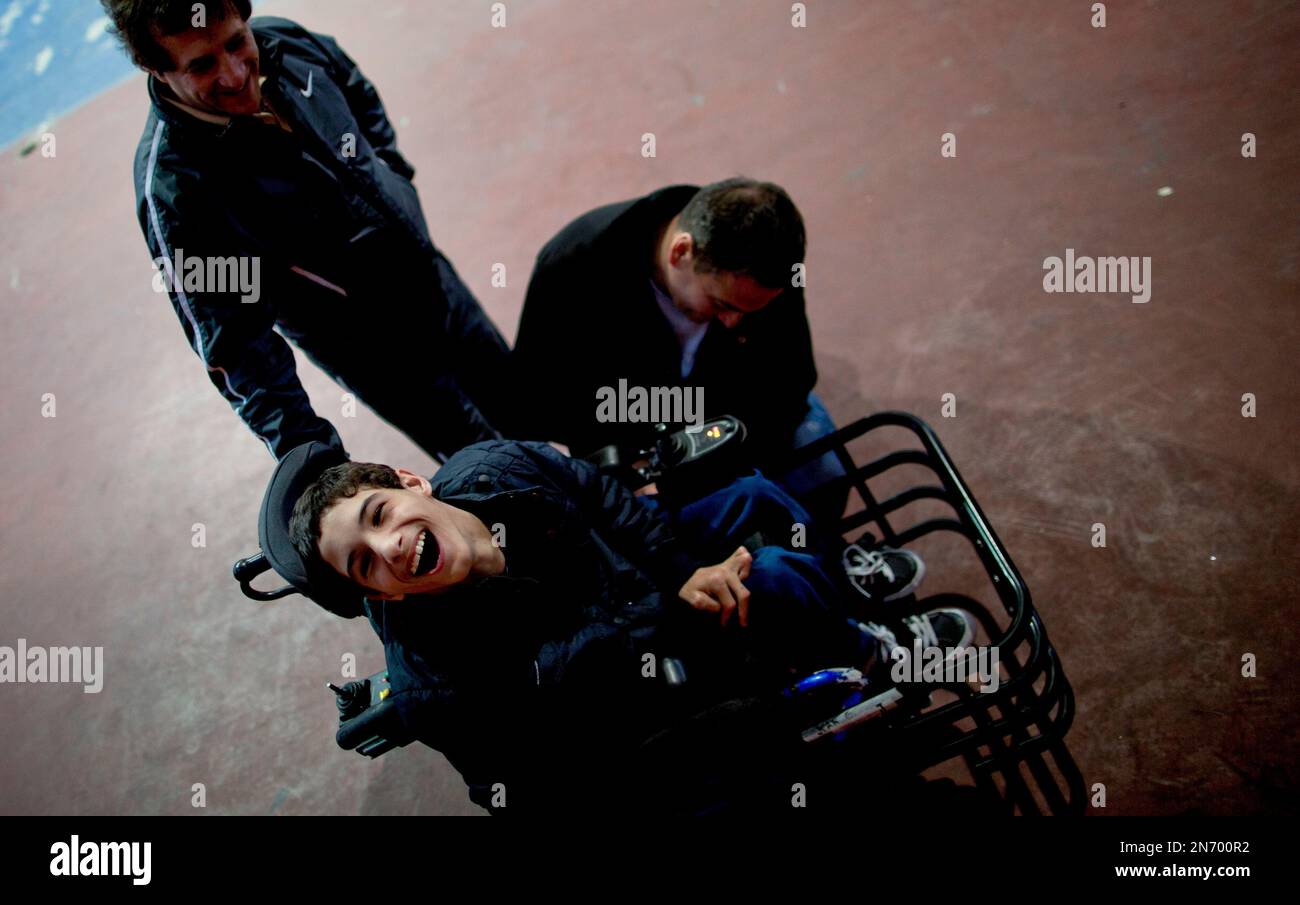 In this July 30, 2013 photo, Juan Gagliardi, left below, laughs as an