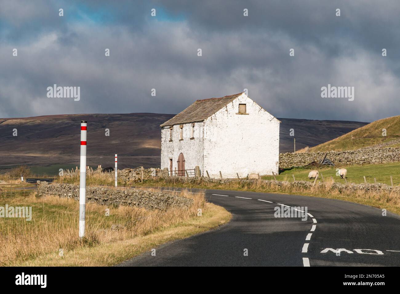 A substantial whitewashed barn on the side of the B6277 road up Teesdale. Stock Photo