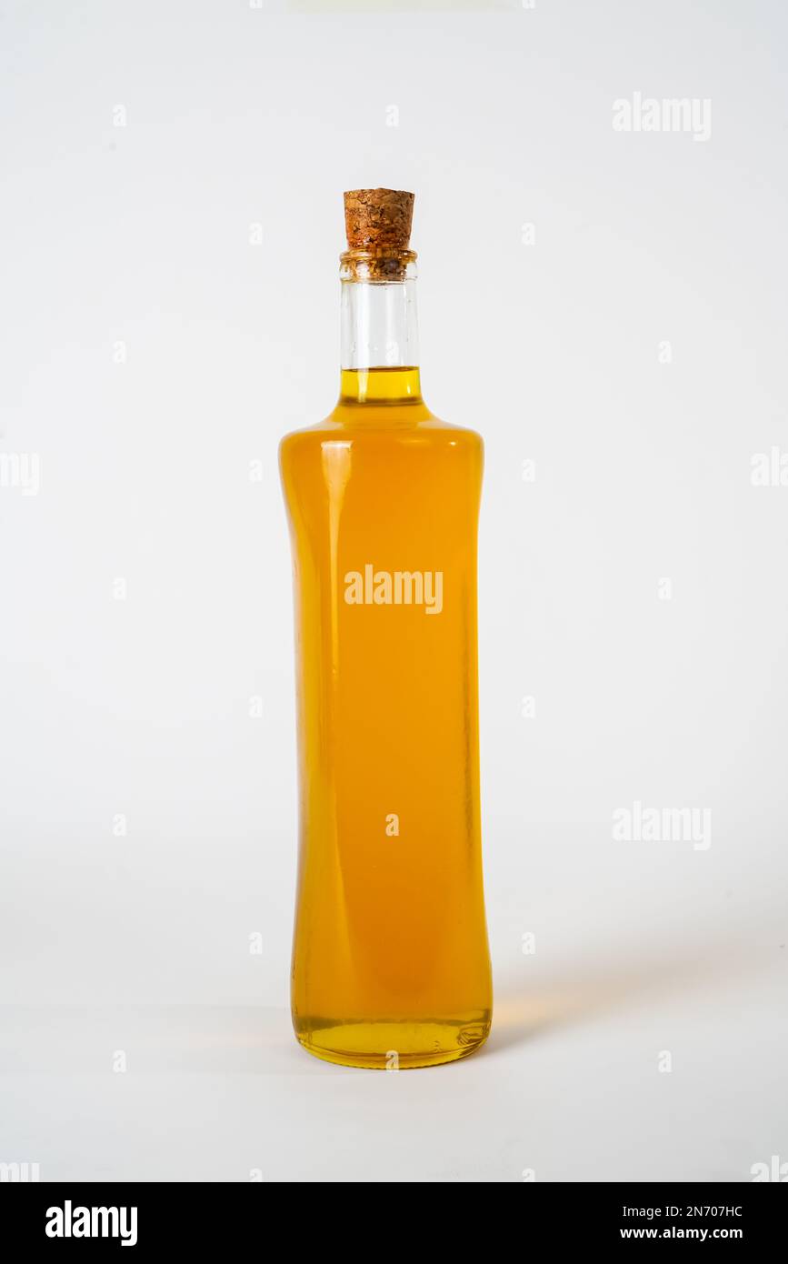 Olive oil in a glass bottle with a cork stopper isolated on white background. Stock Photo