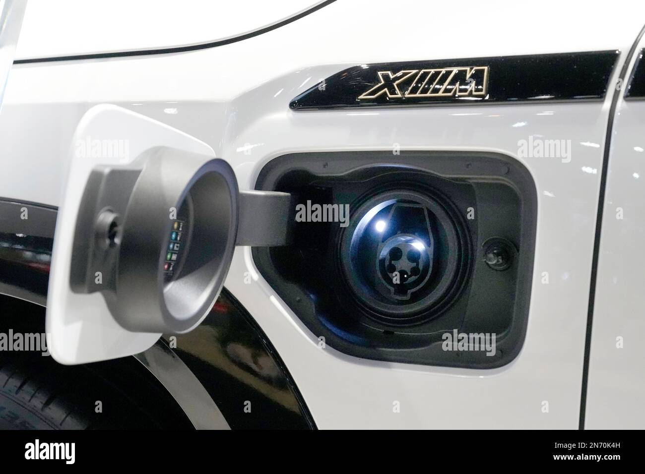 The 2023 BMW XM SUV charging port sits on display at the Chicago Auto ...