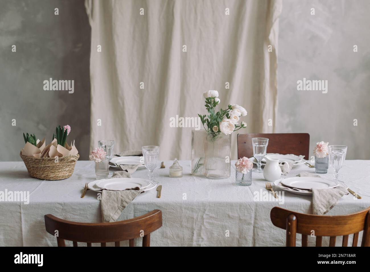 Table setting with pink hyacinths and spring flowers Stock Photo