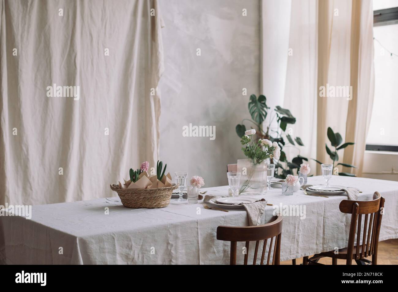 Table setting with pink hyacinths and spring flowers Stock Photo