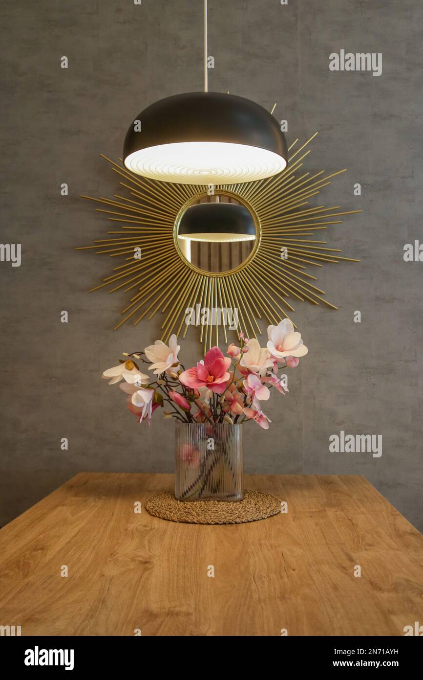 Dining table in the kitchen with pink flowers bouquet in the vase