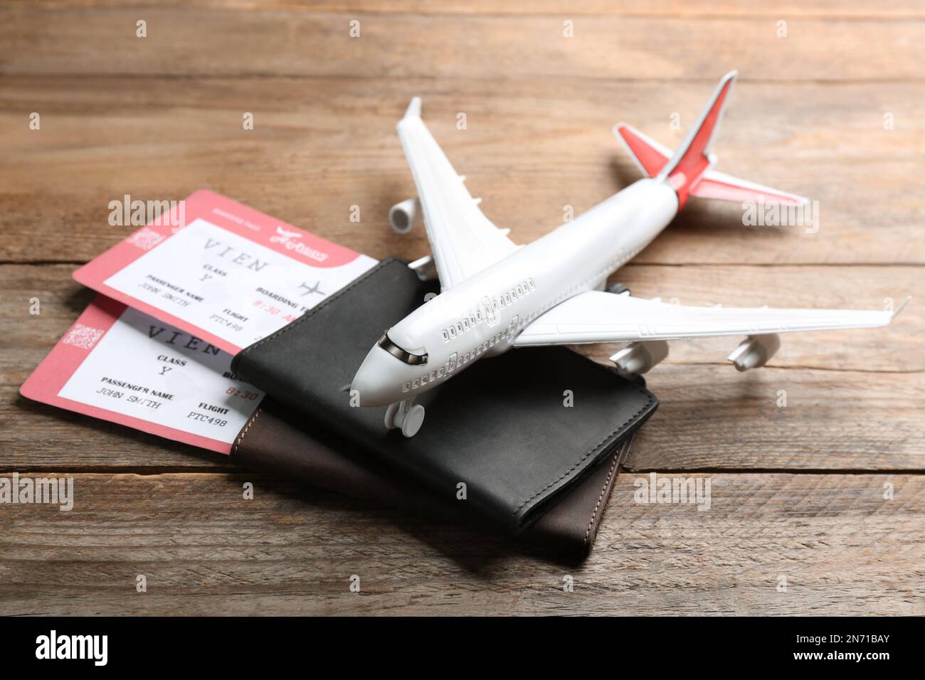 Toy airplane and passports with tickets on wooden background Stock Photo