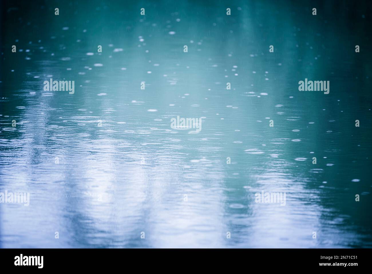 Rain drops in water during rainy weather Stock Photo