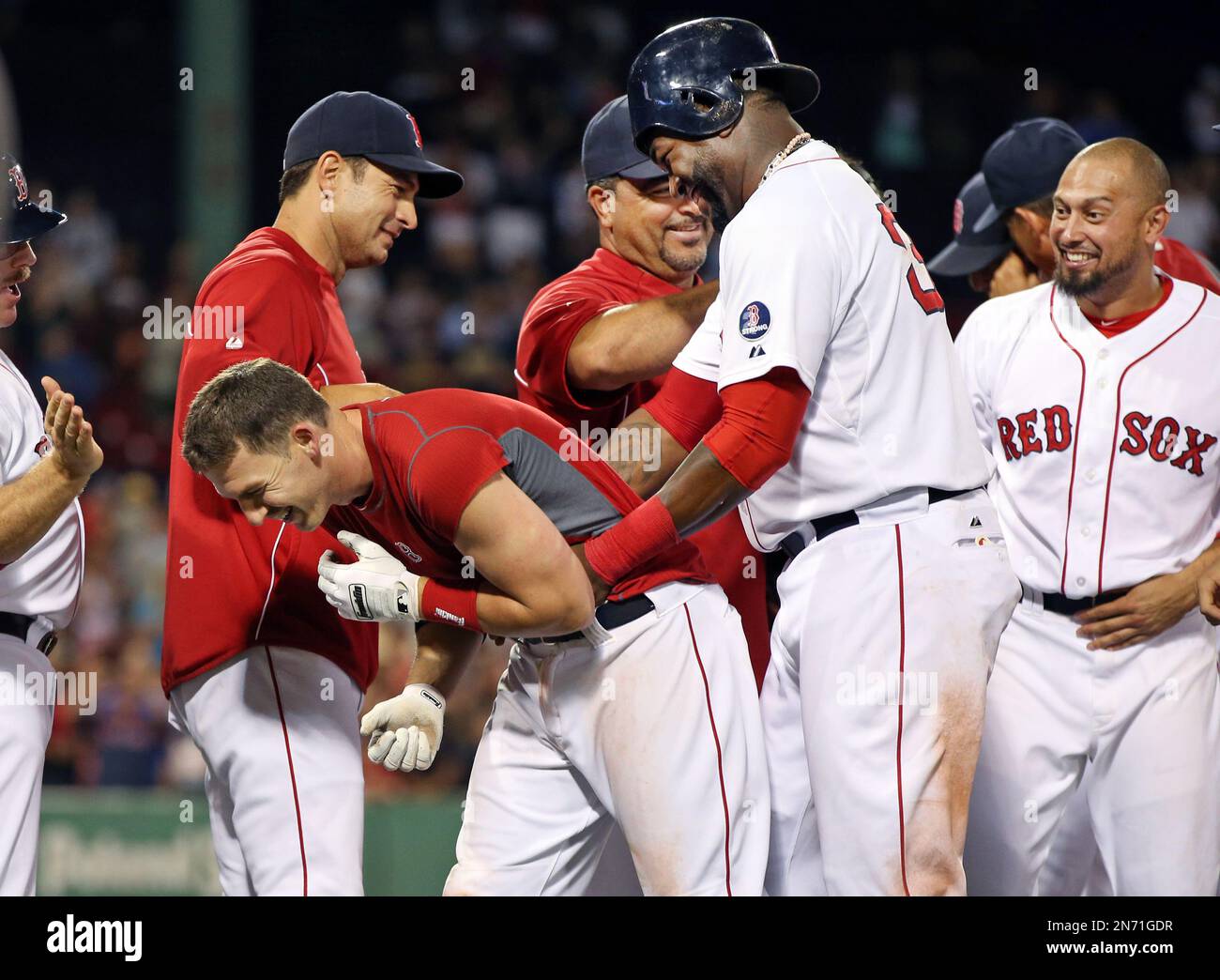 Boston Red Sox's Stephen Drew, bent over left, celebrates with