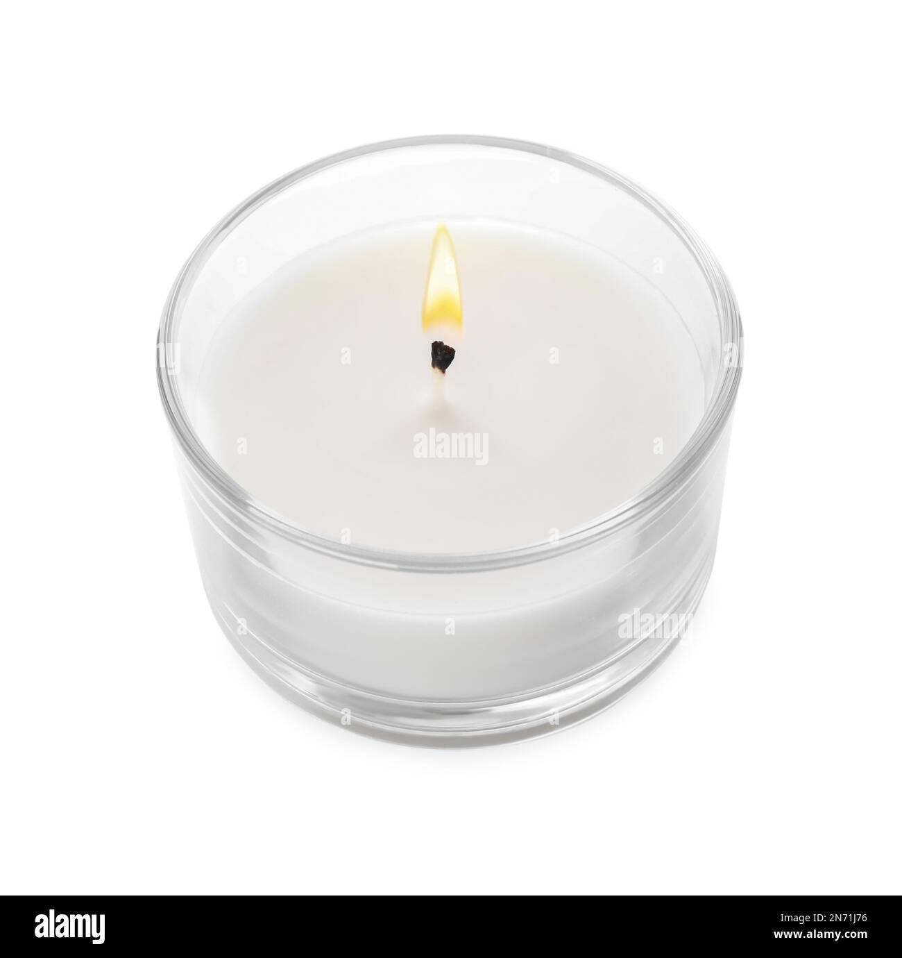 Burning small wax candle in glass holder isolated on white Stock Photo