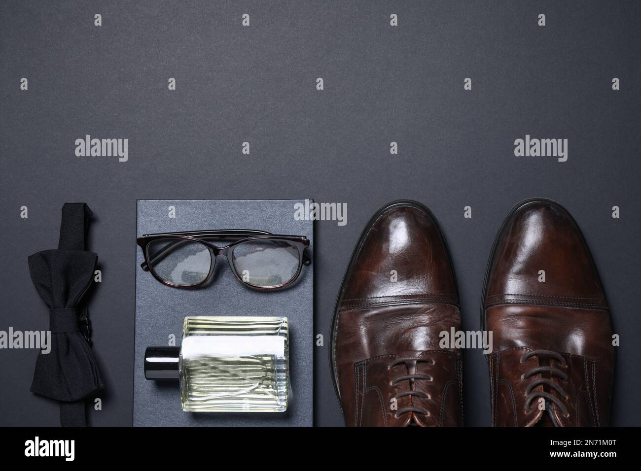 Set of men's accessories on dark grey background, flat lay. Space for ...