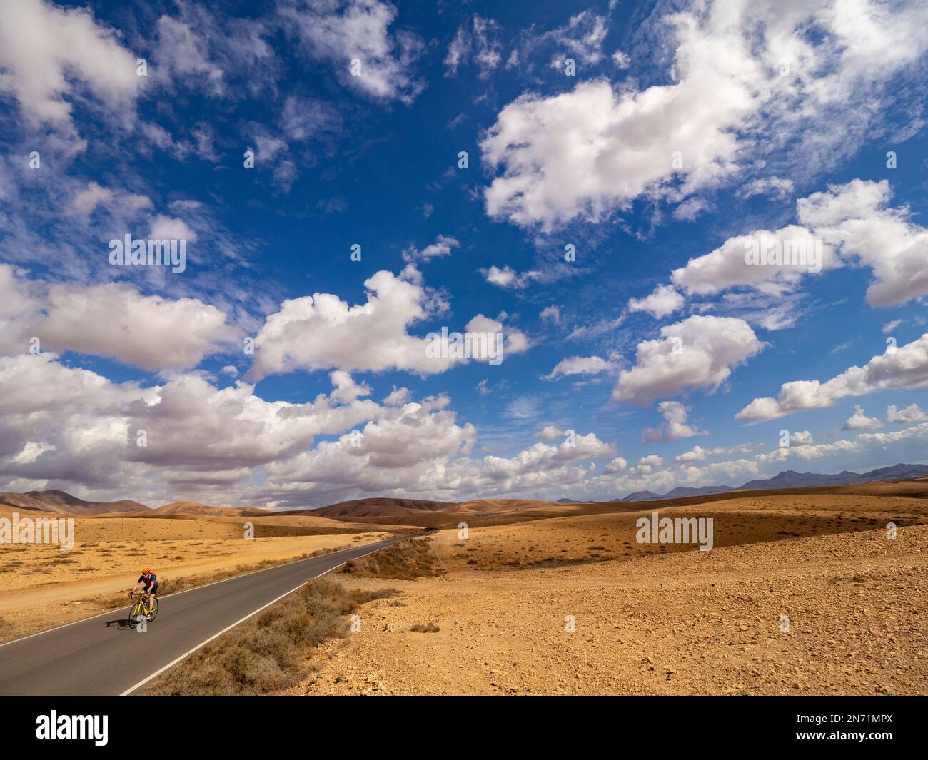 Road cyclist on side road in the central hill country of Fuerteventura, near Tesejerague, Canary Islands, Spain Stock Photo
