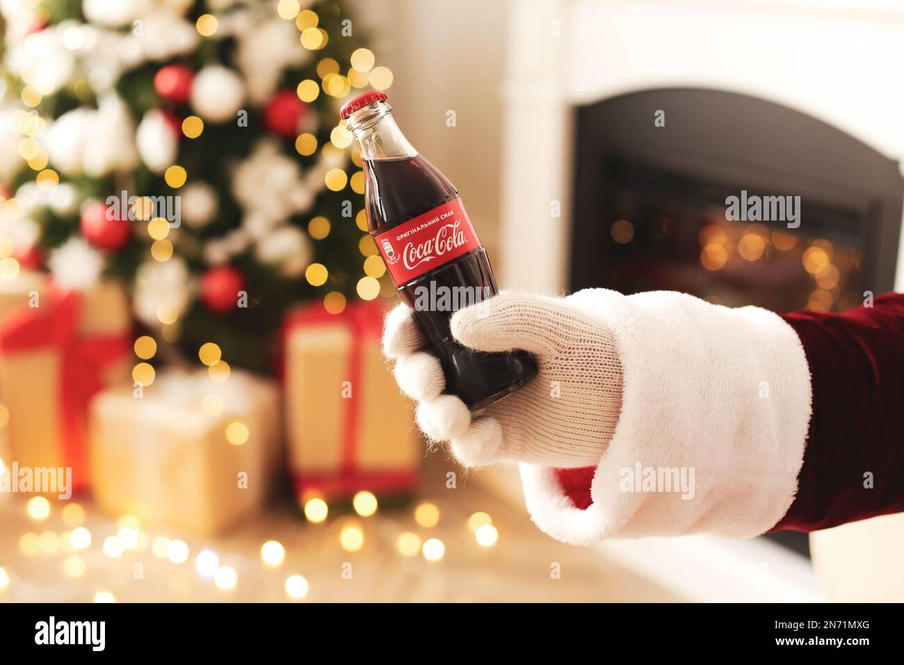 Lviv, Ukraine - December 1, 2017: Coca cola bottle, stylish bow tie, santa  socks and kit kat on straw in gift box with christmas lights. Top view. Gif  Stock Photo - Alamy
