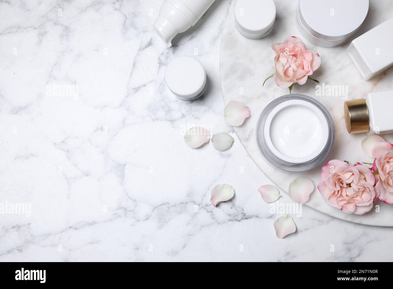 Flat lay composition with different skin care products and flowers on ...