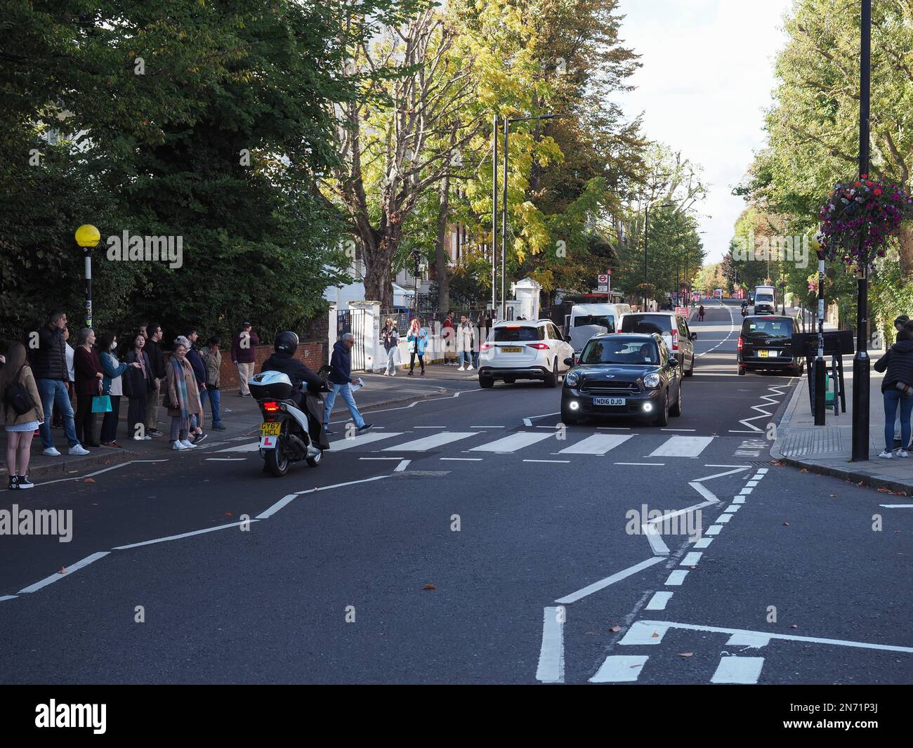 LONDON, UK - CIRCA OCTOBER 2022: People crossing Abbey Road zebra