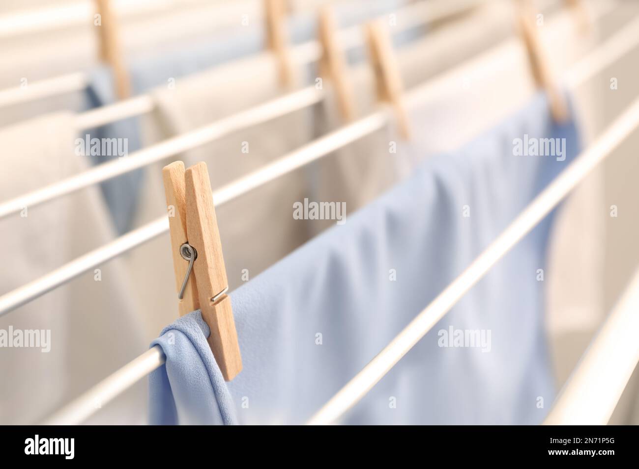 Clean laundry hanging on drying rack, closeup Stock Photo