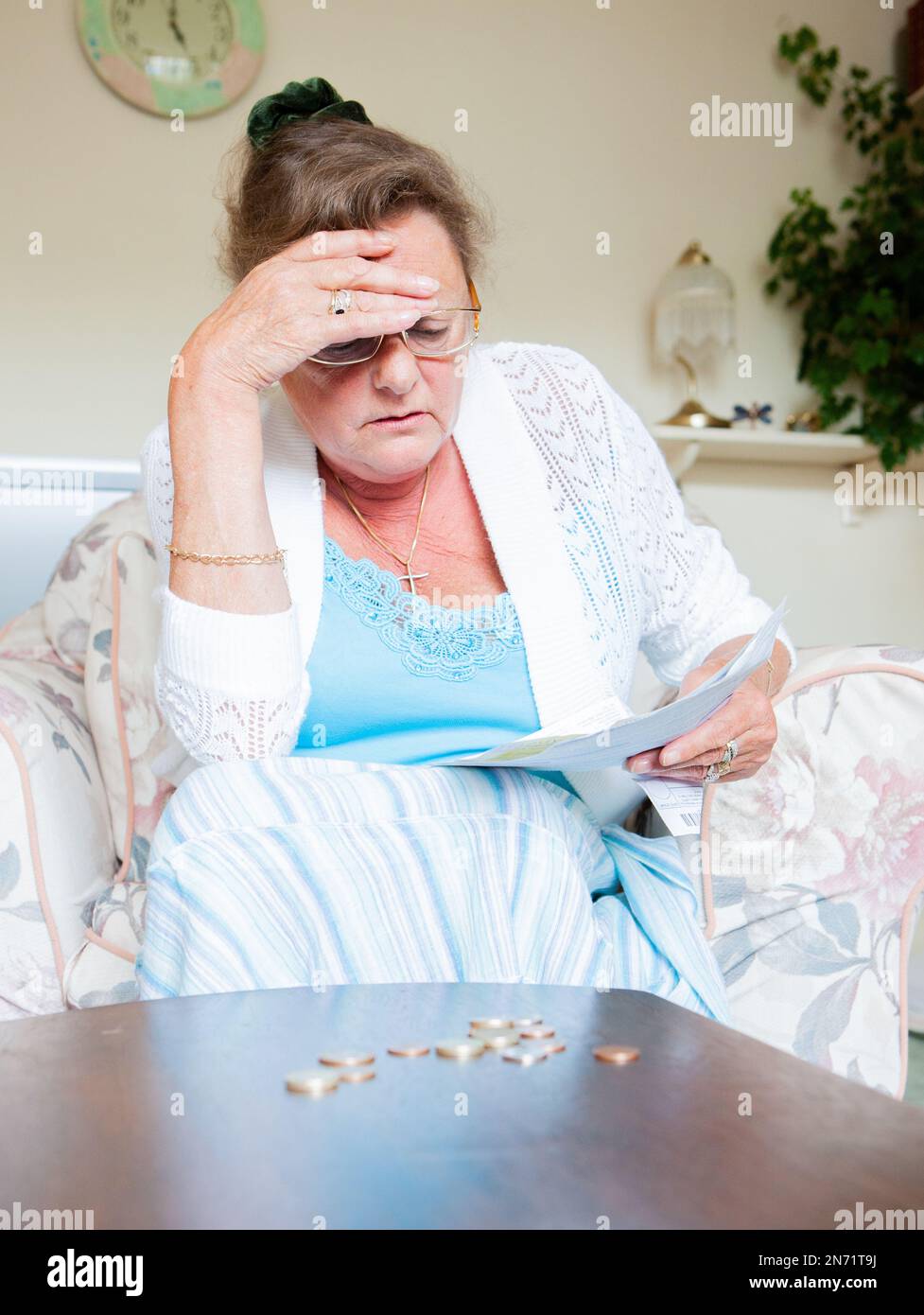 Retirement: Cost of Living. A senior lady frustrated by the rising cost of her domestic bills. From a series of related images. Stock Photo