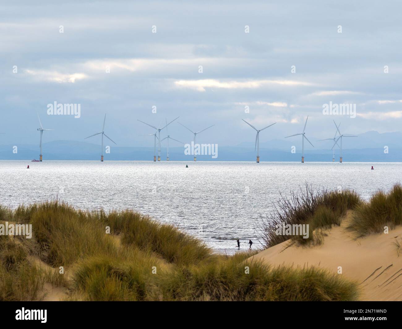 Off shore wind turbines in the sea off Formby Point Sefton Coast Merseyside with sand dunes in the foreground Stock Photo