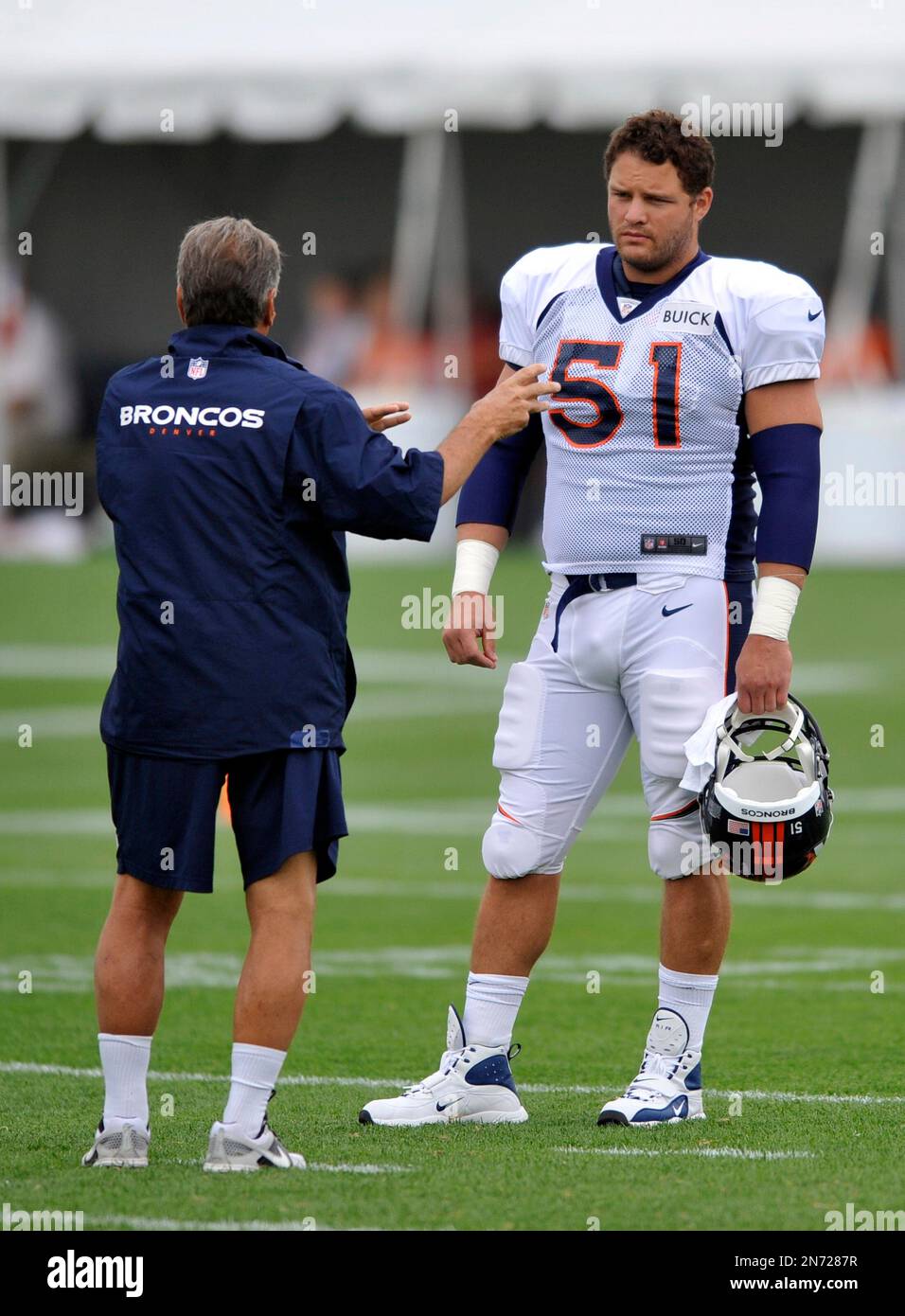 Newly signed Denver Broncos center Steve Vallos (51) talks with