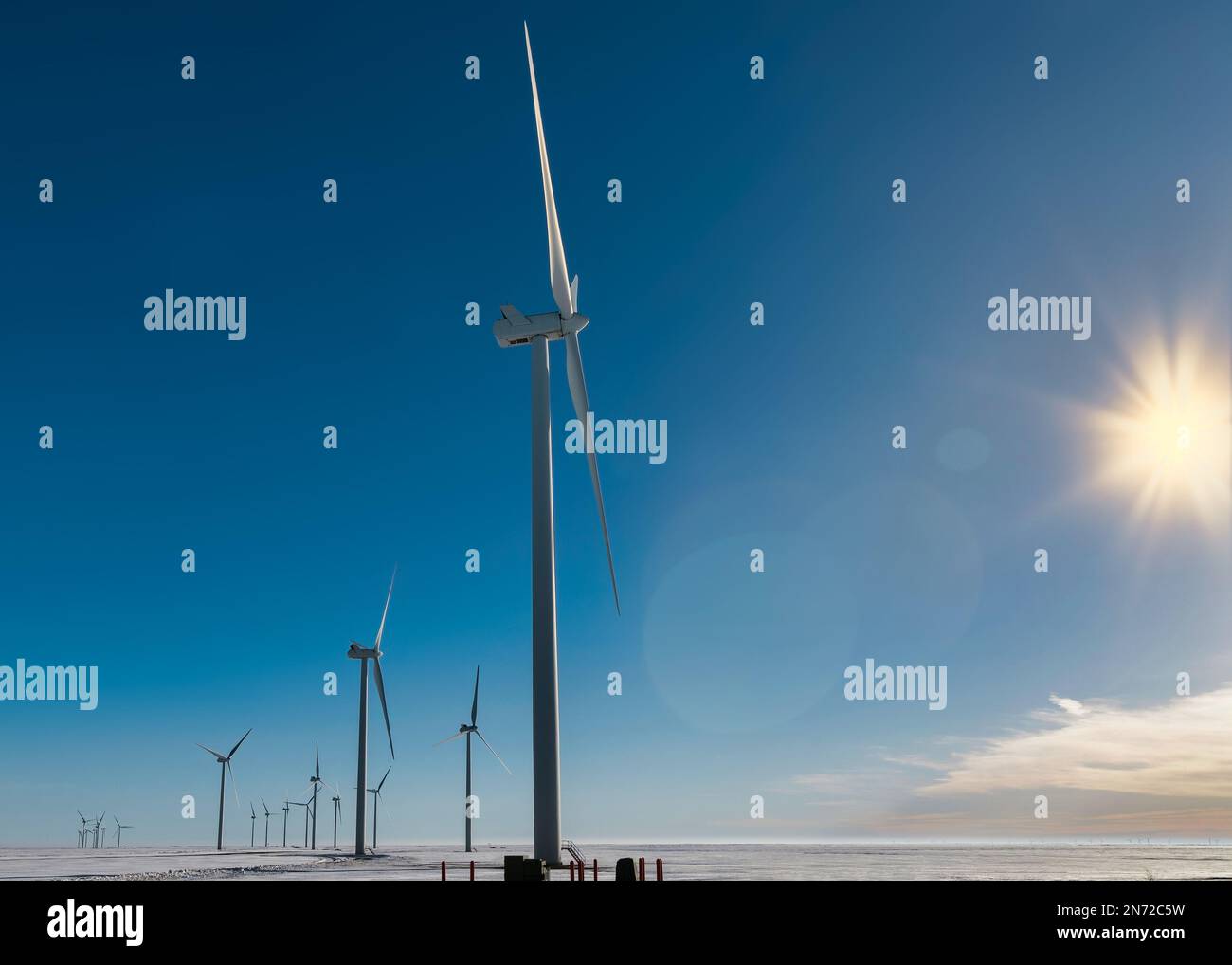 The winter sun shines on a wind farm in rural area near Limon, Colorado