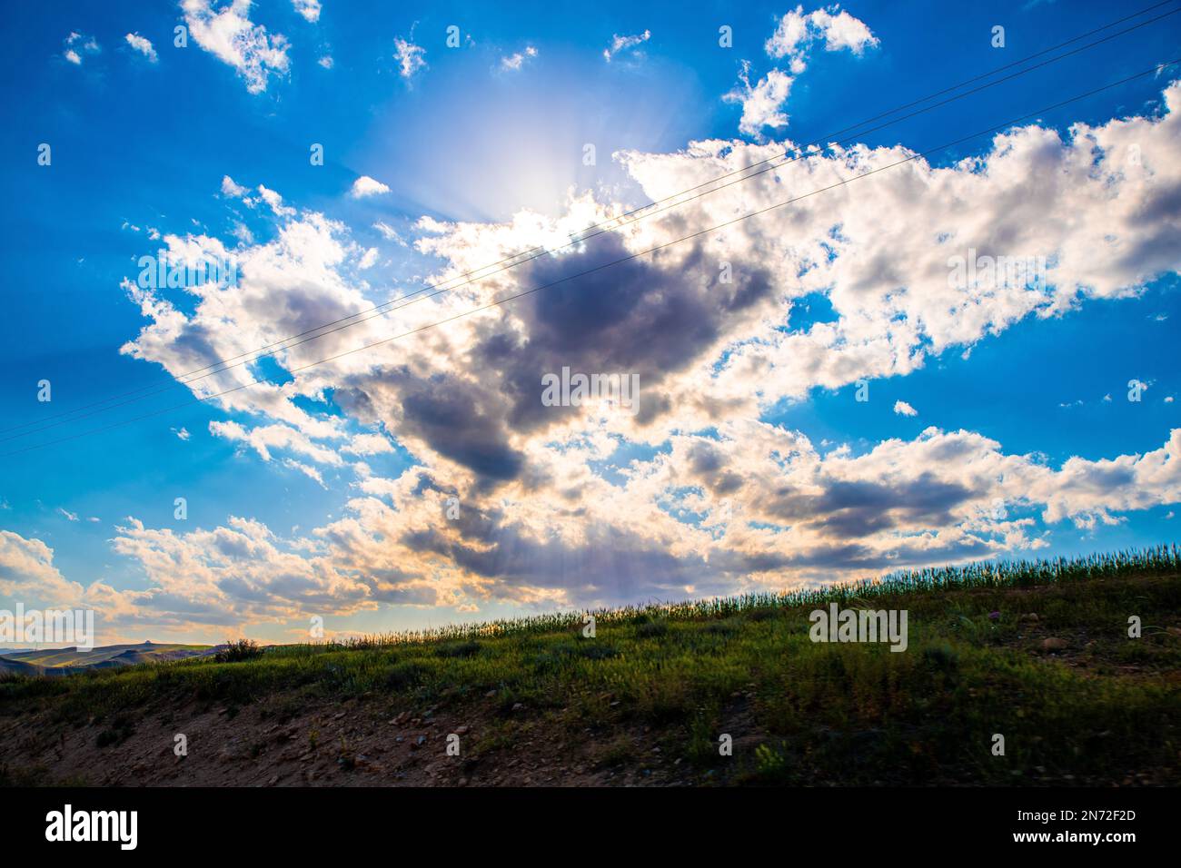The sun hiding behind the clouds over the rural Zanjan province in Iran Stock Photo