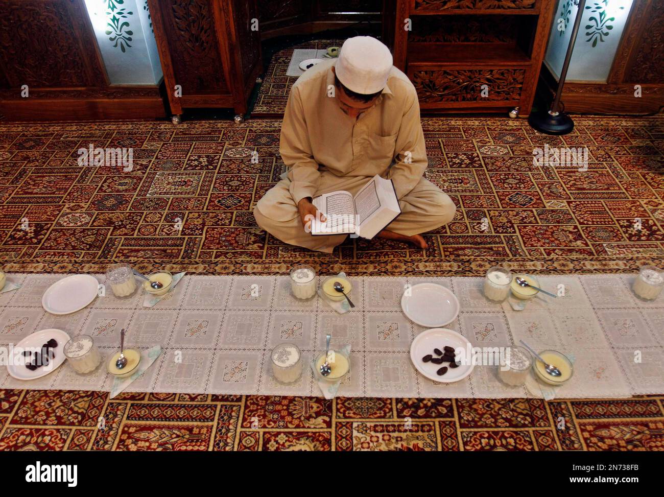 A Kashmiri Muslim man reads verses from the Quran, Islam's holy book ...