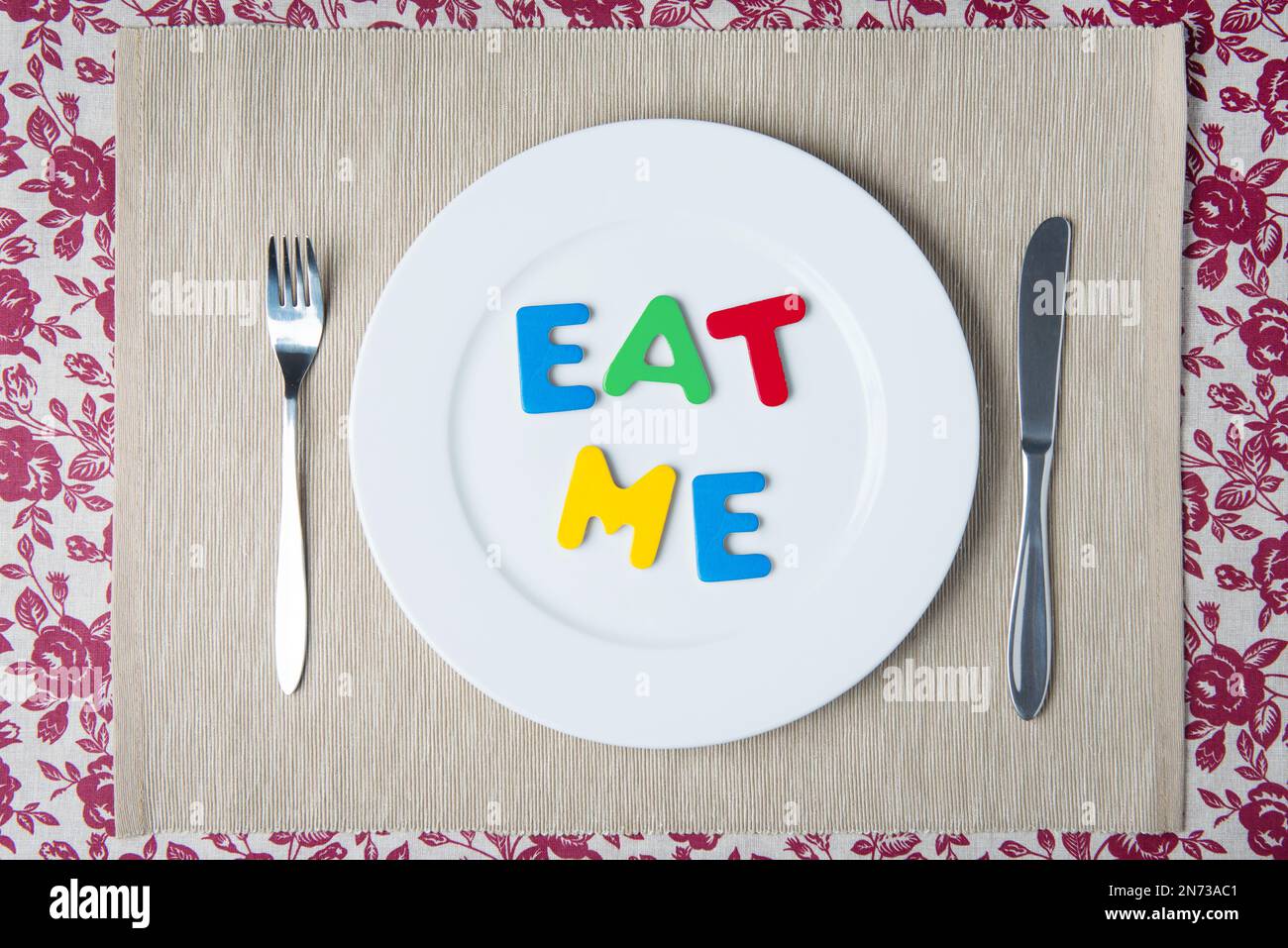 Concept: healthy food and diet - word EAT ME on a white plate Stock Photo