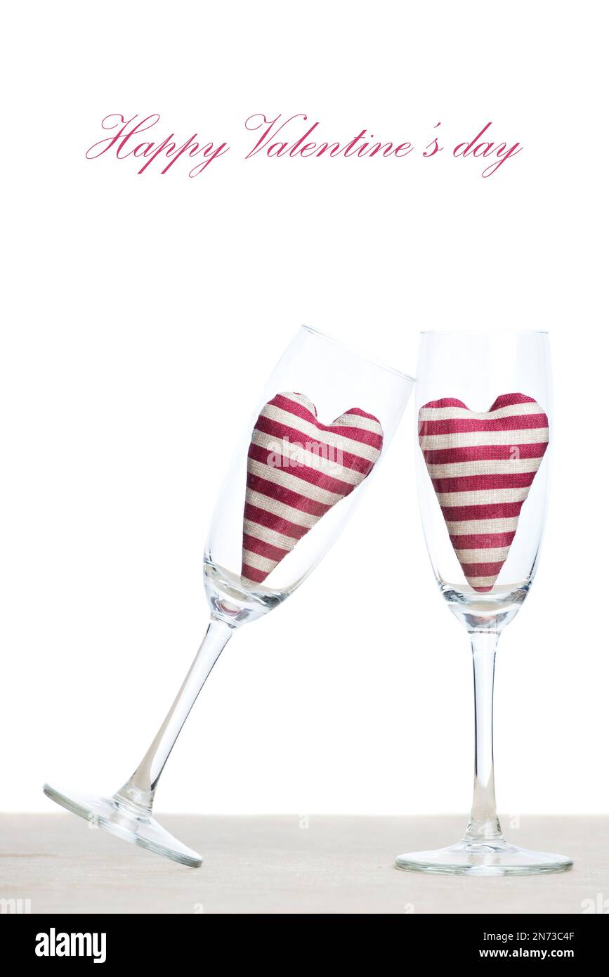 Valentine card - two stripped hearts in champagne glasses Stock Photo