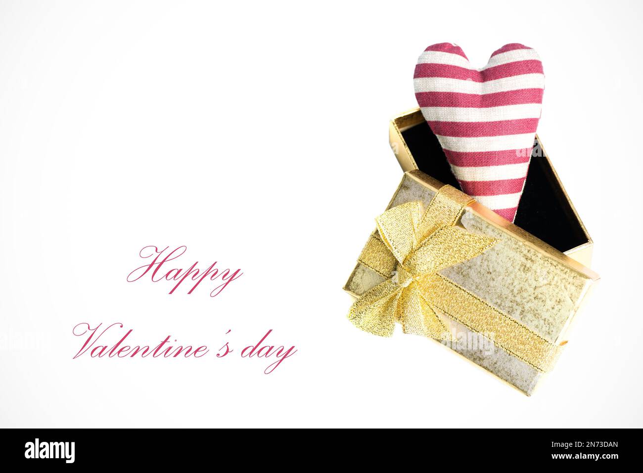 Valentine's day card - Golden gift box with red striped heart inside on white background with vignette Stock Photo