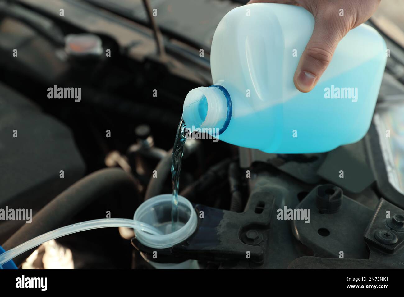 adding winter windscreen washer fluid in the car Stock Photo - Alamy