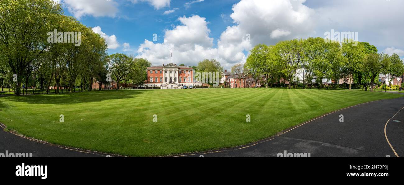 Panoramic view of Warrington Town Hall under a cloudy skyline and lush green garden in Warrington Cheshire, England. Stock Photo