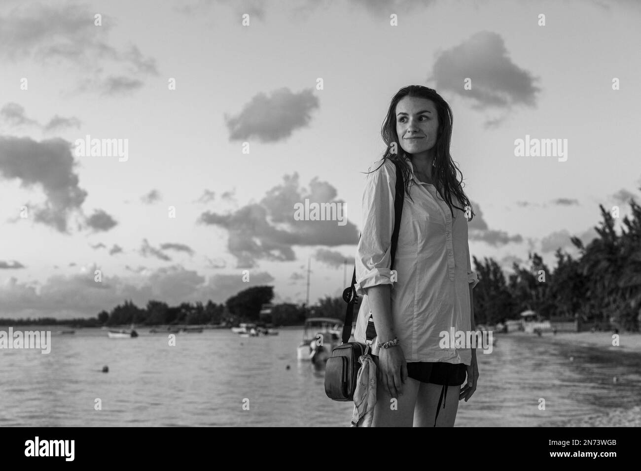 A young female model enjoying the evening sun at one of the beaches at the westcoast of mauritius island, Africa Stock Photo