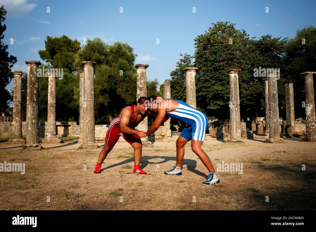 Greece's two times bronze world champion freestyle wrestling athlete Ioannis Arzoumanidis, left