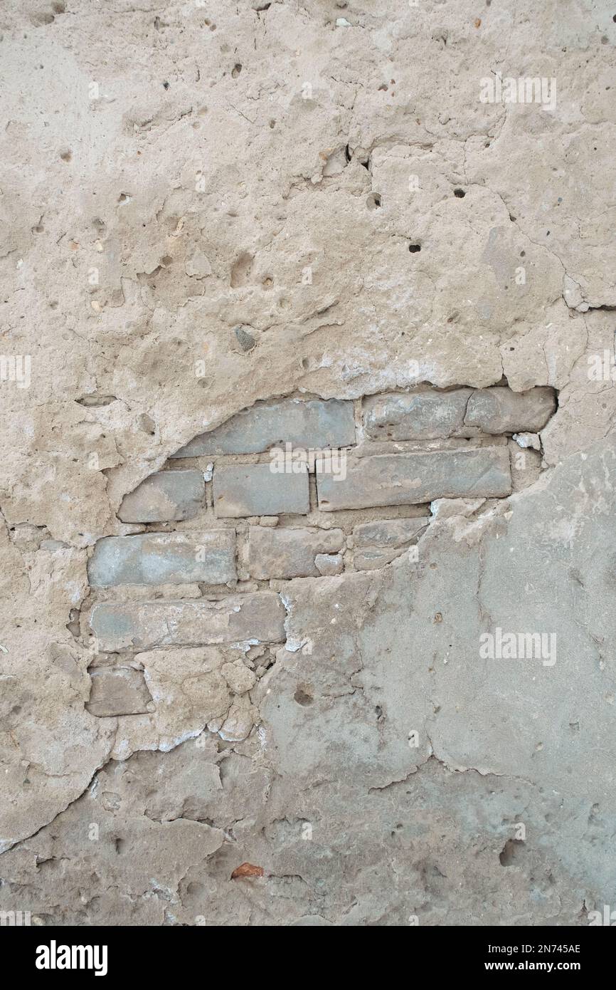 Old brick wall with peeling plaster Stock Photo