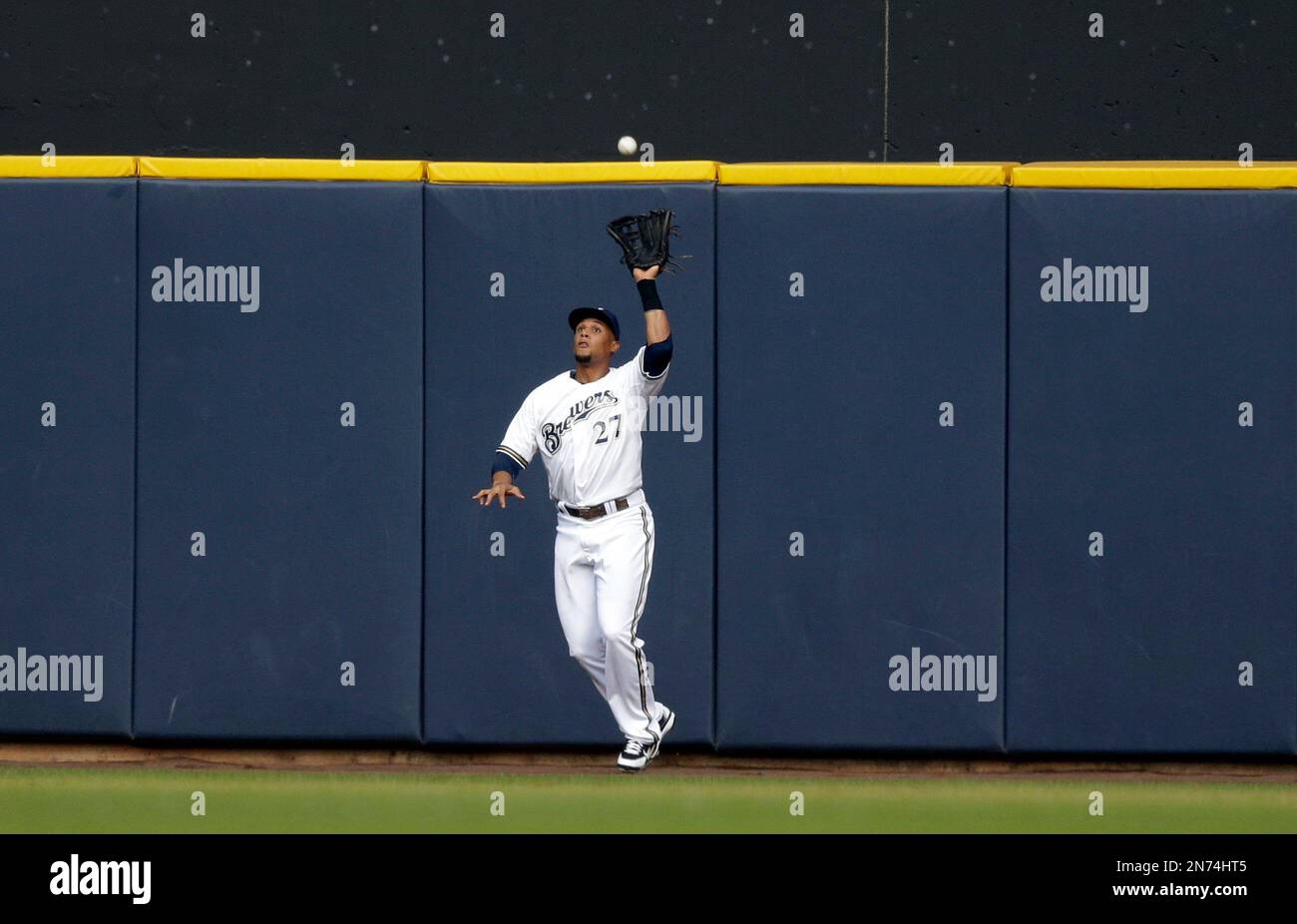 Carlos Gomez of the Milwaukee Brewers makes a catch at the wall