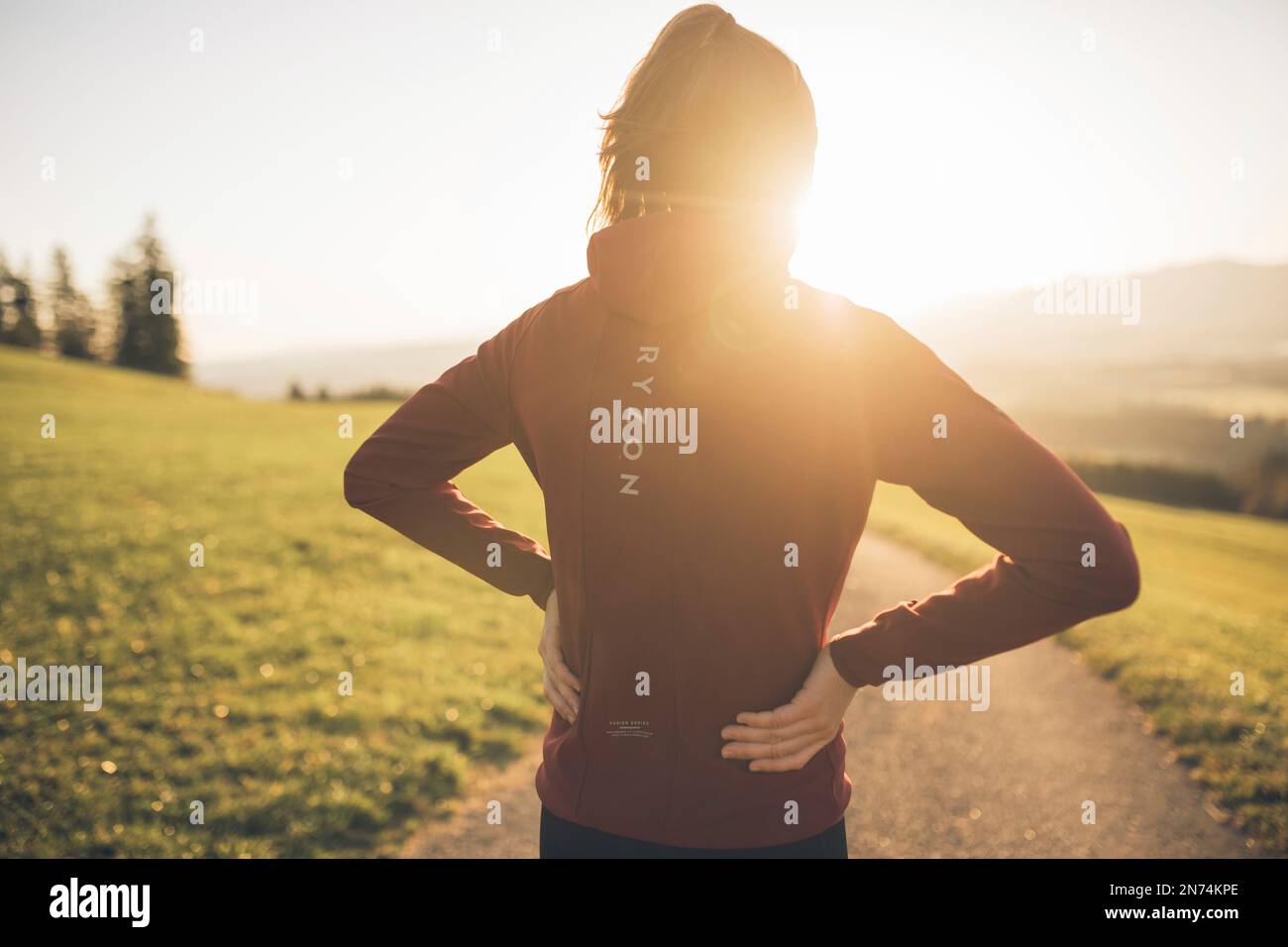 Professional triathlete running, morning atmosphere, sunrise, Auerberg, Allgäu, Bavaria, Germany Stock Photo