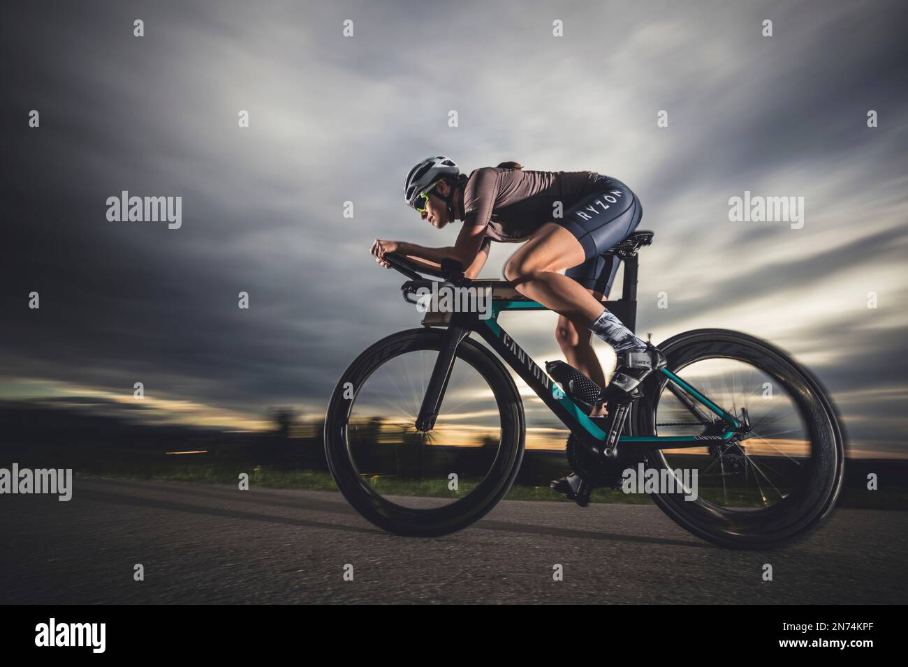 Professional triathlete on her road bike, time trial bike round