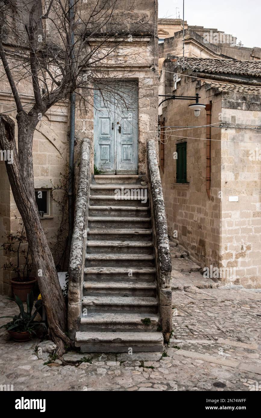 Abandoned staircase leading to a closed door in the typical Italian town of Matera, Italy Stock Photo
