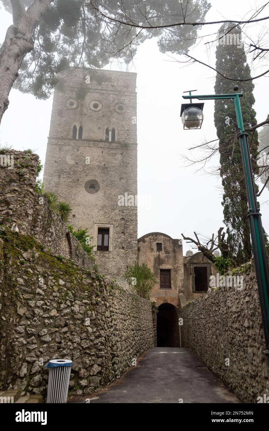 An empty alleyway and the tower of Villa Rufolo during fog, Ravello in Italy Stock Photo