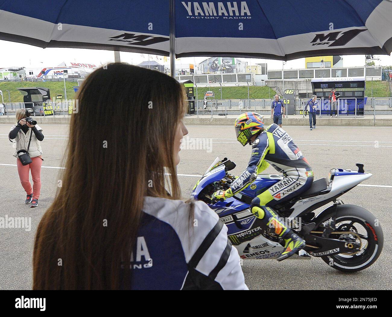 Yamaha rider Valentino Rossi of Italy arrives in the paddock during the MotoGP free practice at the Sachsenring circuit in Hohenstein-Ernstthal, near the city of Chemnitz, Germany, Saturday, July 13, 2013