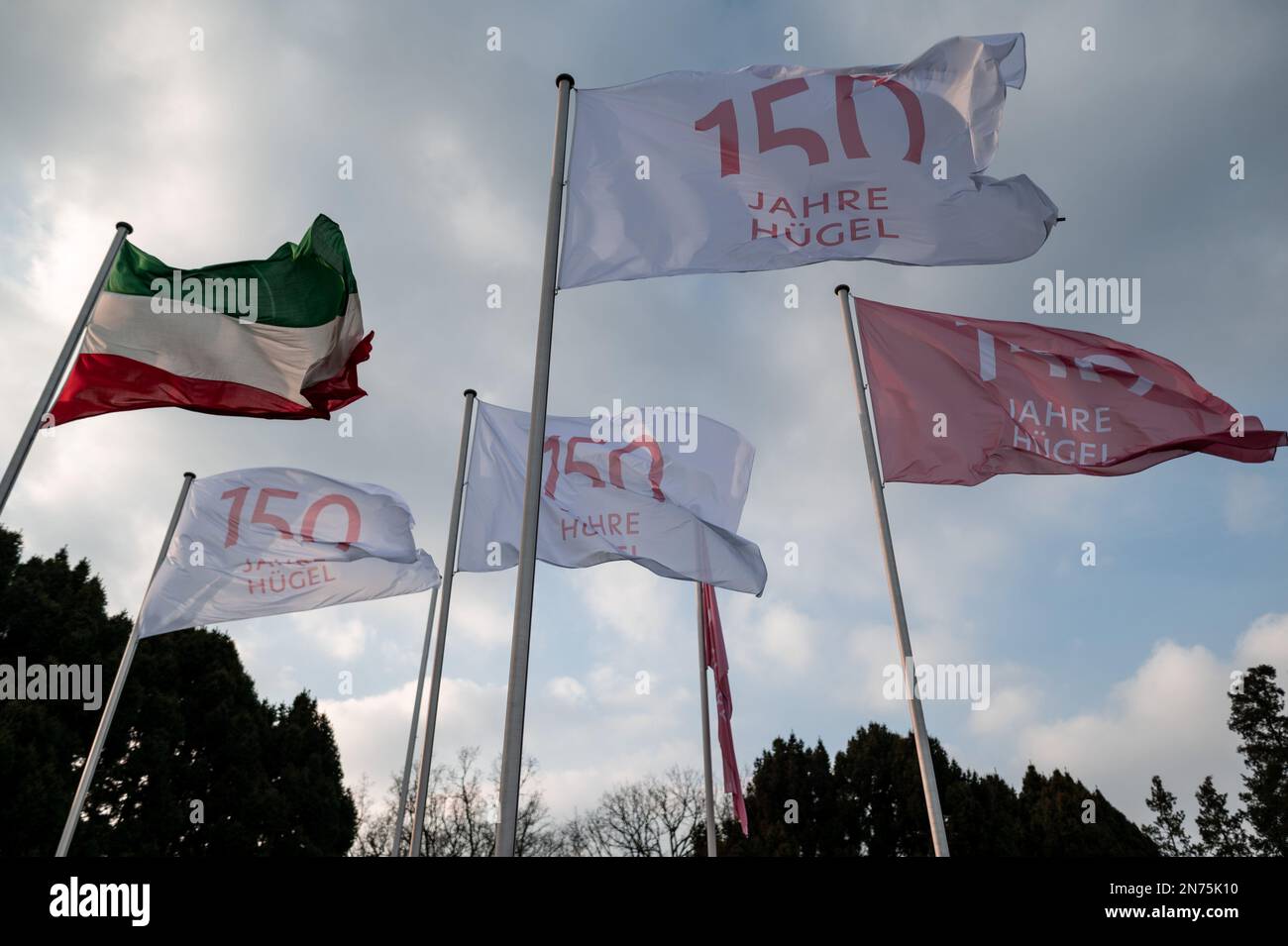 Essen, Germany. 10th Feb, 2023. Flags in front of the villa read '150 years of Hügel'. The celebration of the 150th 'Hügel anniversary' takes place at Villa Hügel in Essen. The highlight of the ceremony is the official opening of the transmedia real-time installation 'kontraste' by Federal President Steinmeier. Credit: Fabian Strauch/dpa/Alamy Live News Stock Photo