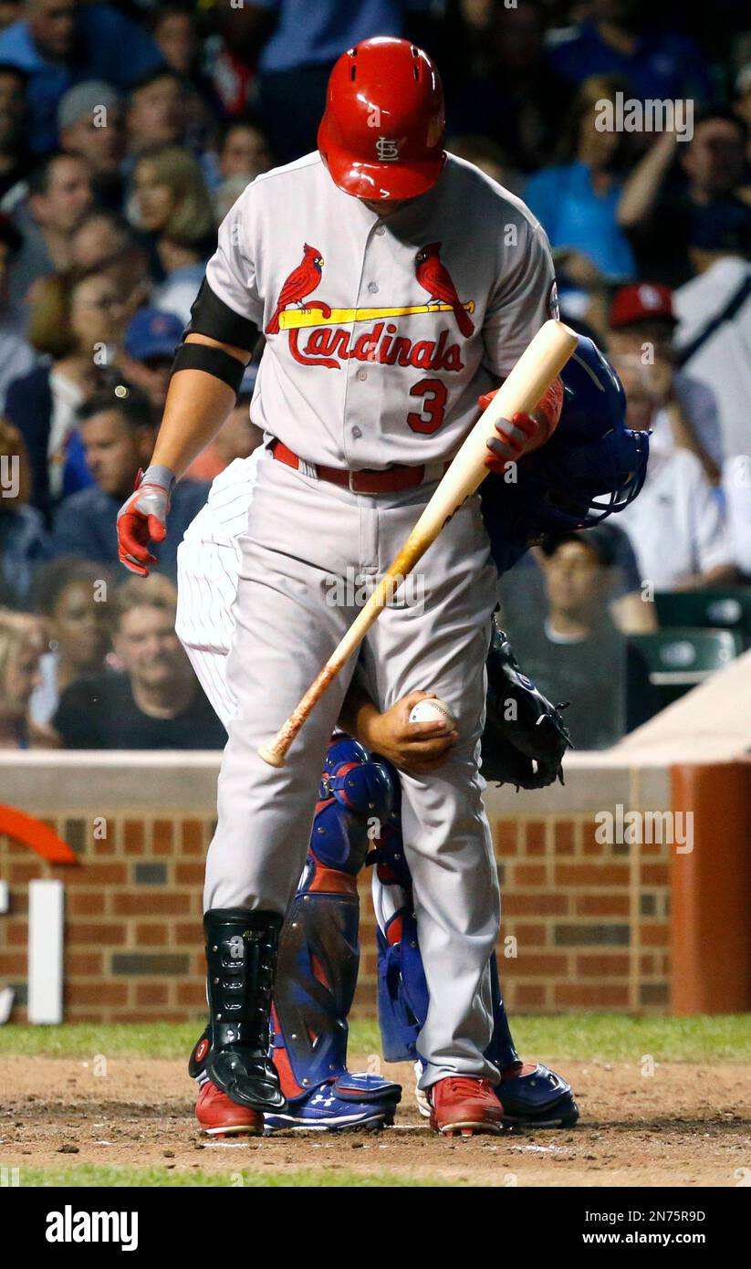 Chicago Cubs catcher Welington Castillo reaches between the legs of St