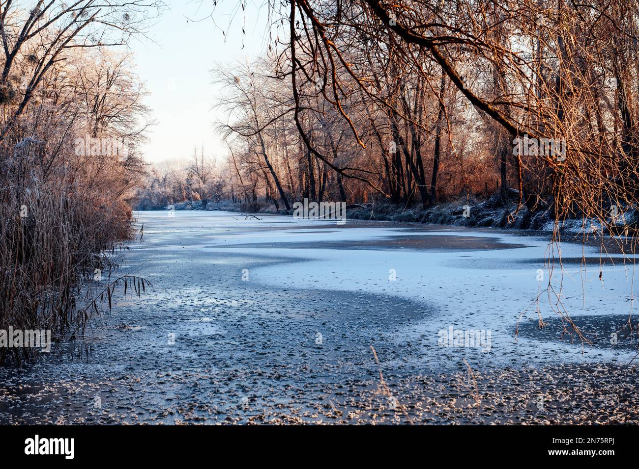 View into the frozen Golm branch canal on a winter morning with winter sun Stock Photo