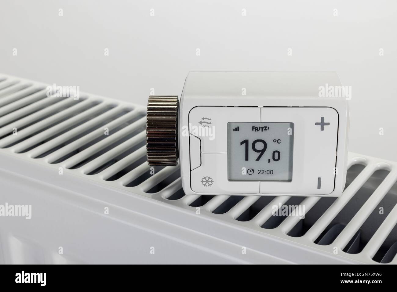 WLAN radiator thermostat FRITZ! DECT 302, display shows 1ö°C., on radiator,  symbol image, change thermostat, smart home technology, networking,  digital, energy costs, rising heating costs, white background Stock Photo -  Alamy