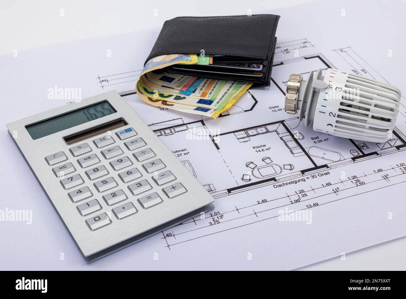 Black wallet, calculator, radiator thermostat, lie on construction