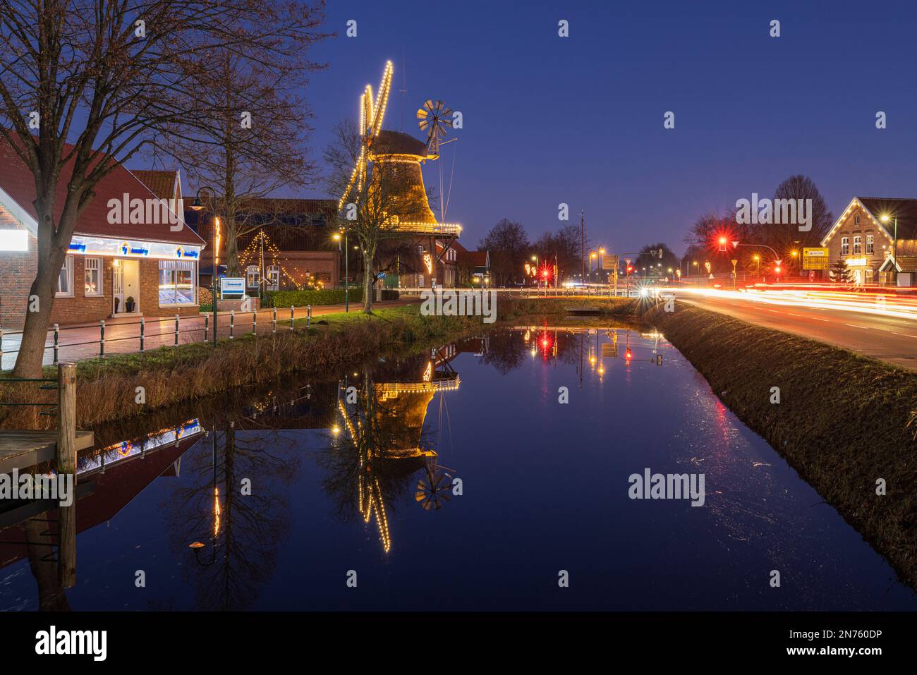 Illuminated windmill at Christmas time at the Großefehn Canal in Ostgroßefehn, Aurich County, East Frisia, Lower Saxony, Stock Photo
