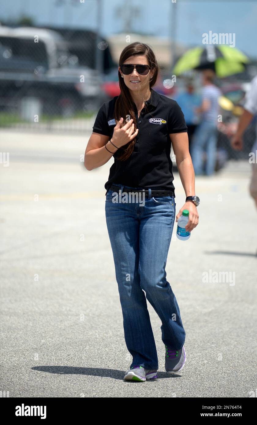 Danica Patrick walks through the garage area before a practice session for  the NASCAR Sprint Cup auto race at Daytona International Speedway in  Daytona Beach, Fla., Thursday, July 4, 2013.(AP Photo/Phelan M.