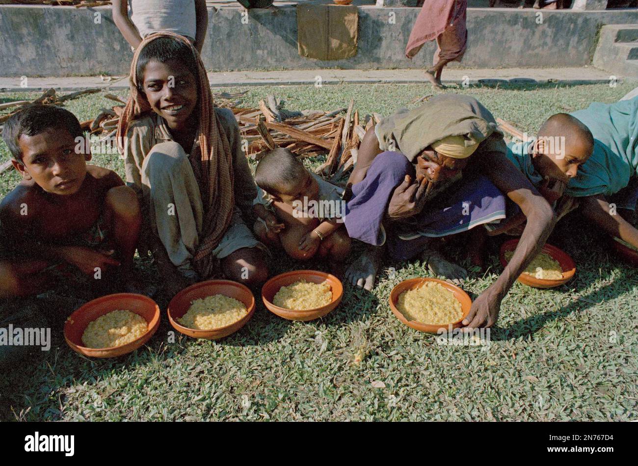 Victims of the Bhola cyclone eat rice after relief supplies reached ...