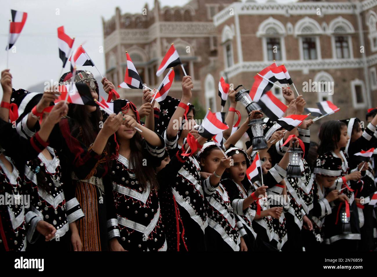 Yemeni girls wearing traditional costumes, attend a festival for