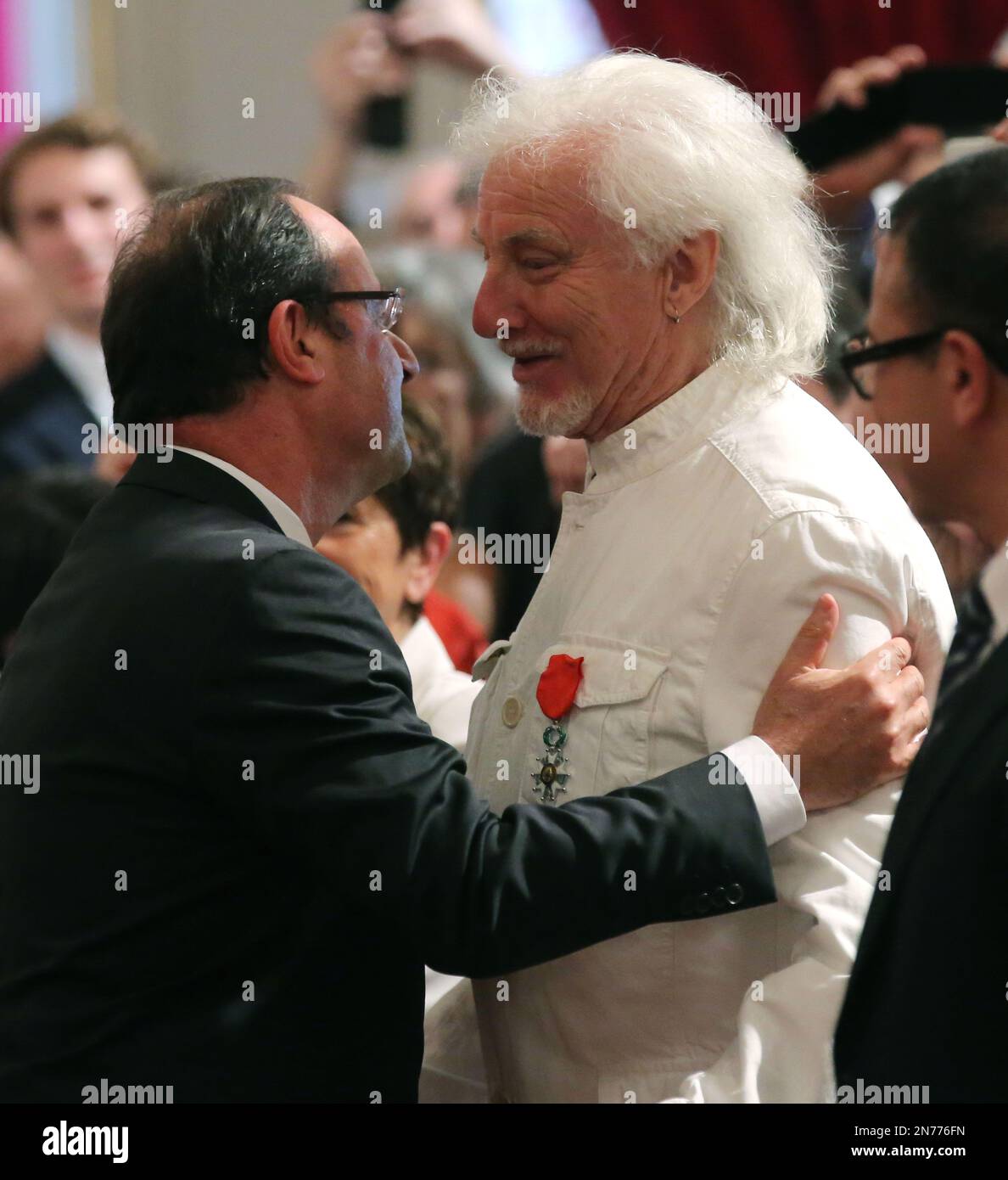 French President Francois Hollande, left, awards the medal of Chevalier 