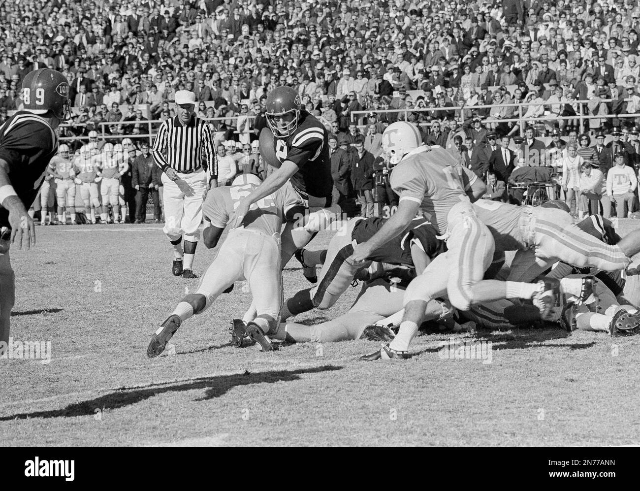 Ole Miss quarterback Archie Manning (18) fumbles the ball on the goal line as he is hit by Tennessee's Jackie Walker (52) in the game at Jackson, Miss., Nov. 15, 1966. Ole Miss tailback Randy Reed, blocking at right, fell on the ball in the end zone to score. Ole Miss took an early lead over third-ranked Tennessee and had an upset in the making. (AP Photo/LG) Stock Photo